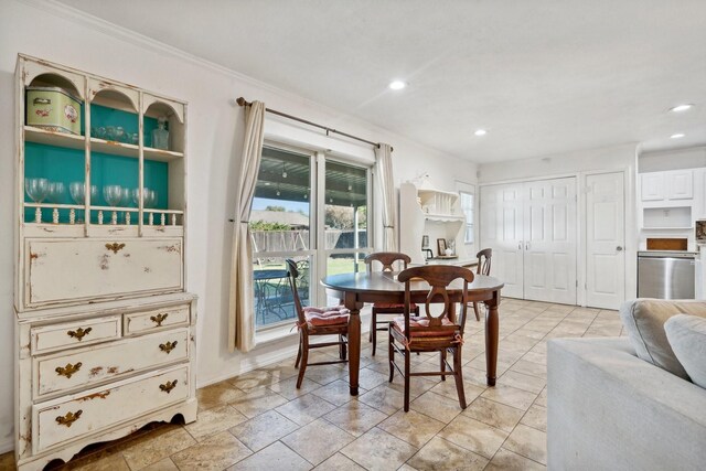 dining space featuring crown molding