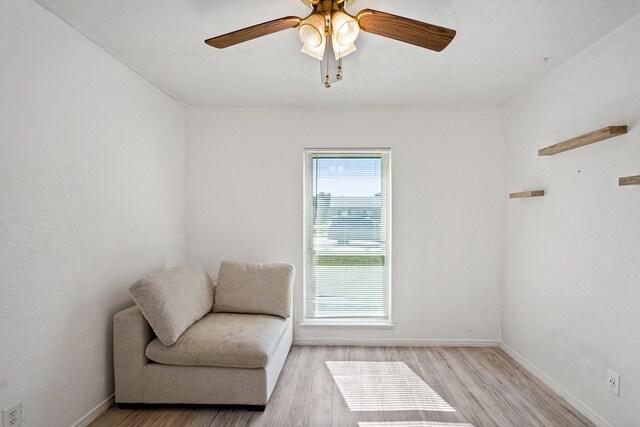 sitting room featuring ceiling fan and light hardwood / wood-style flooring