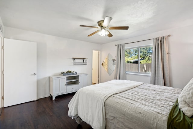 bedroom with ceiling fan and dark wood-type flooring