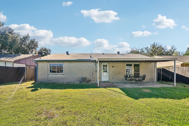 rear view of property featuring a lawn and a patio area