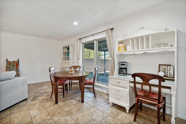 dining space featuring crown molding