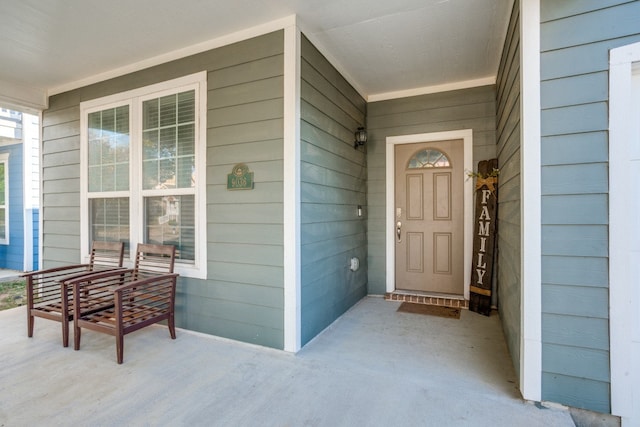 view of exterior entry with a porch