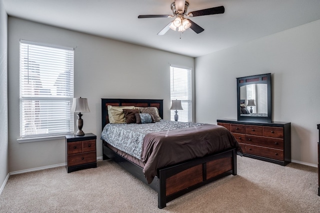 carpeted bedroom with multiple windows and ceiling fan