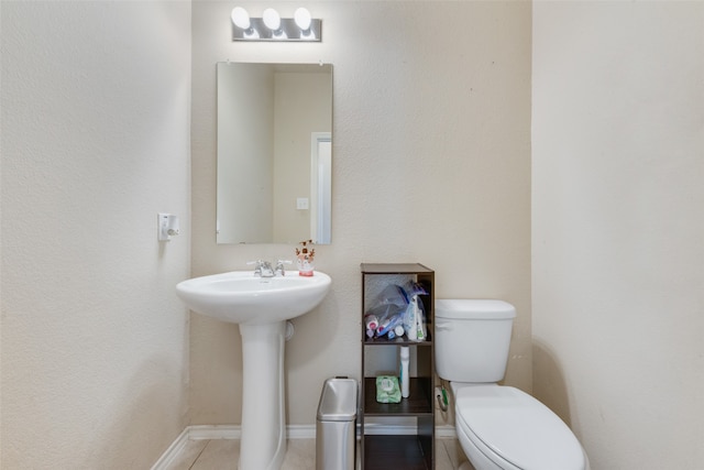 bathroom with tile patterned flooring and toilet