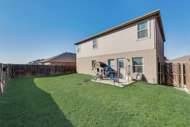 rear view of property with a yard and a patio