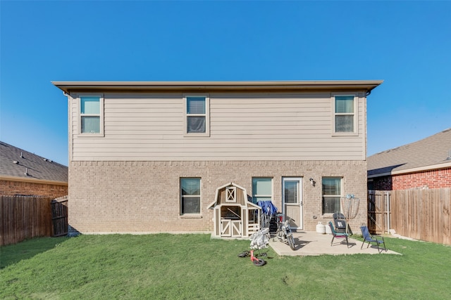 rear view of property with a patio area and a yard