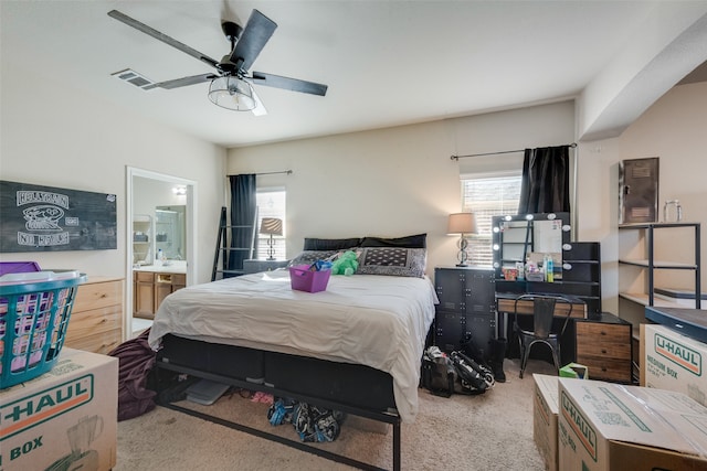 carpeted bedroom featuring ensuite bath and ceiling fan