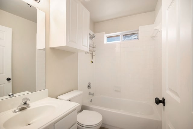 full bathroom featuring sink, tiled shower / bath, and toilet