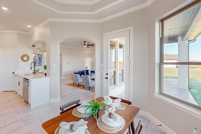 dining room featuring ceiling fan, sink, and ornamental molding