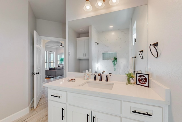 bathroom with ceiling fan, wood-type flooring, and vanity