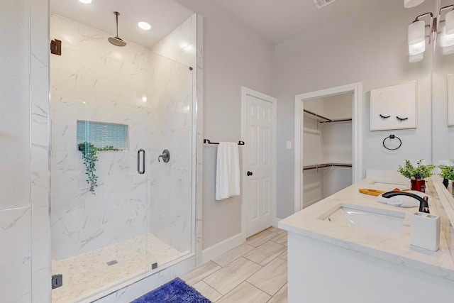 bathroom featuring vanity and a shower with shower door