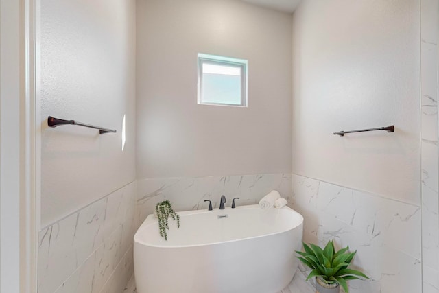 bathroom featuring a bathing tub and tile walls