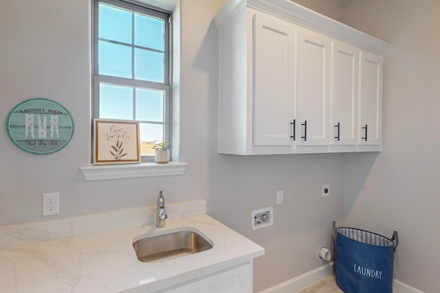 clothes washing area featuring washer hookup, cabinets, sink, and a wealth of natural light