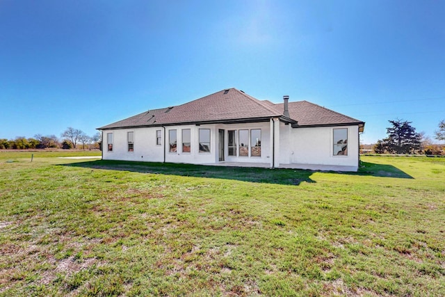 rear view of house with a yard