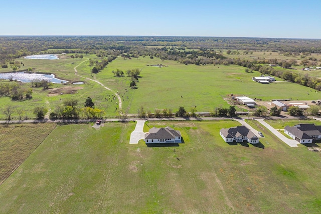 birds eye view of property with a rural view and a water view