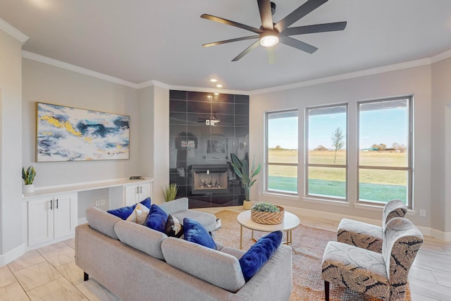 living room with ceiling fan, ornamental molding, and a tile fireplace