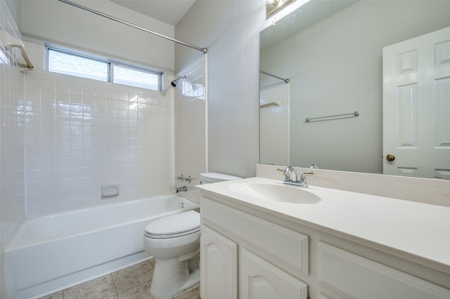 full bathroom with tile patterned floors, vanity, toilet, and tiled shower / bath combo