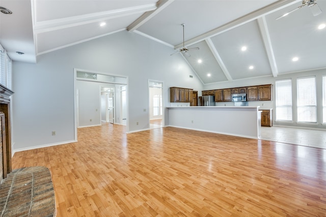 unfurnished living room featuring a brick fireplace, light hardwood / wood-style floors, high vaulted ceiling, and beam ceiling