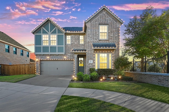 view of front of house with a garage and a yard