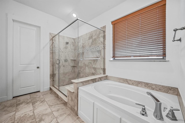 bathroom featuring independent shower and bath