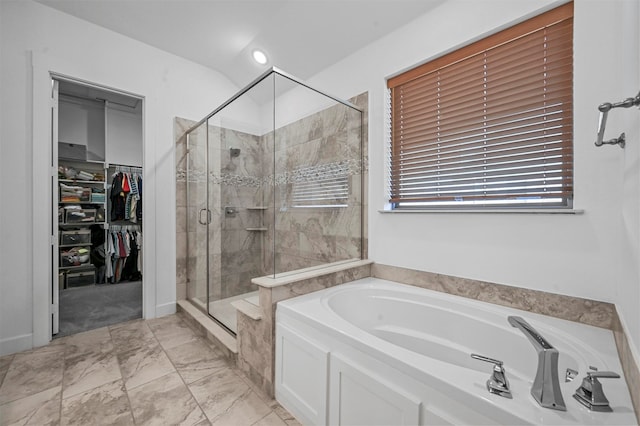 bathroom with lofted ceiling and independent shower and bath