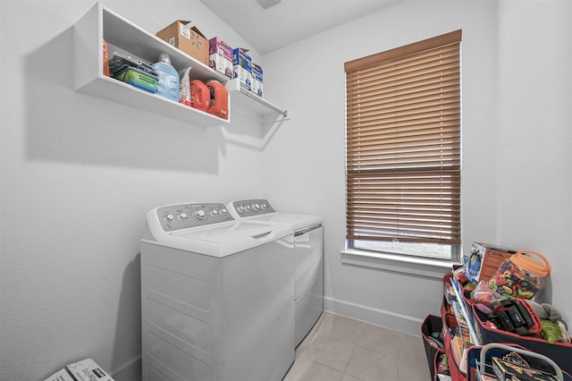 washroom featuring separate washer and dryer and light tile patterned flooring