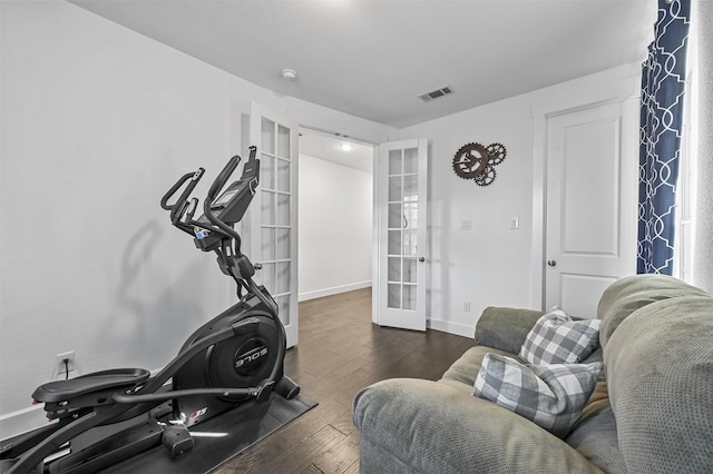 exercise room featuring dark hardwood / wood-style flooring and french doors