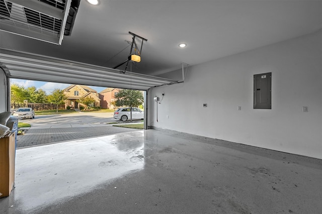 garage with a garage door opener and electric panel