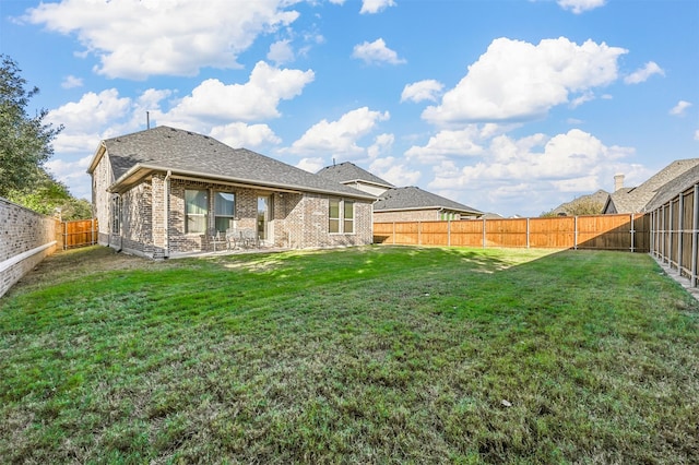 back of house featuring a yard