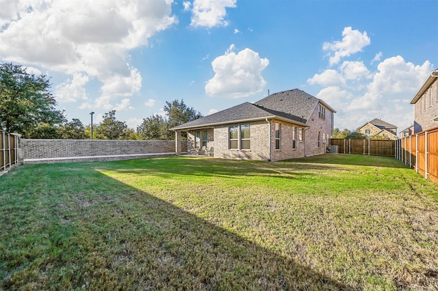 back of property featuring a yard