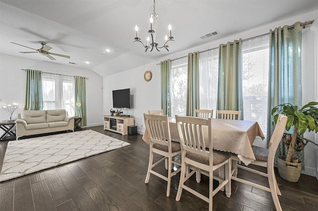 dining space featuring ceiling fan with notable chandelier, dark hardwood / wood-style flooring, and vaulted ceiling