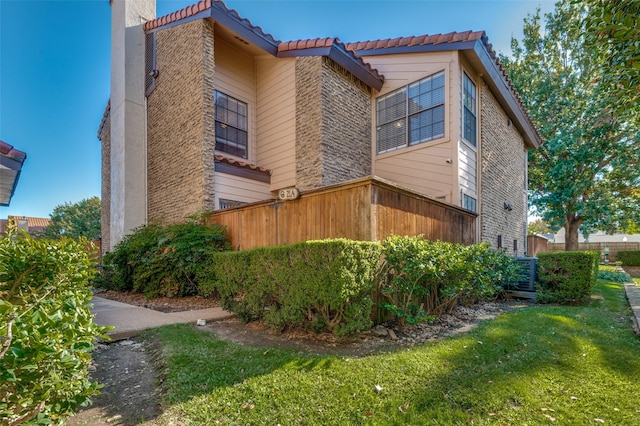 view of side of home with a yard