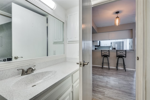 bathroom with wood-type flooring and vanity