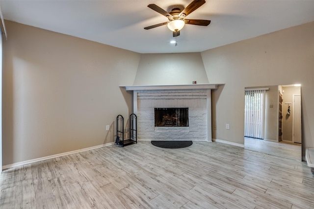 5626 Preston Oaks Rd Unit 21A, Dallas, TX 75254 - unfurnished living room featuring ceiling fan, a fireplace, wood finished floors, and baseboards