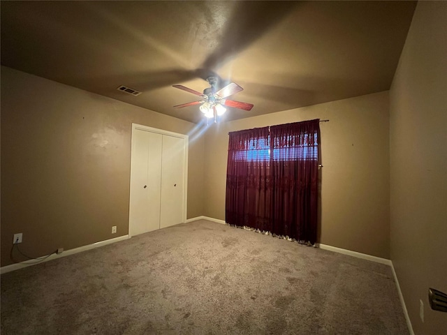 unfurnished bedroom featuring carpet flooring, a closet, and ceiling fan