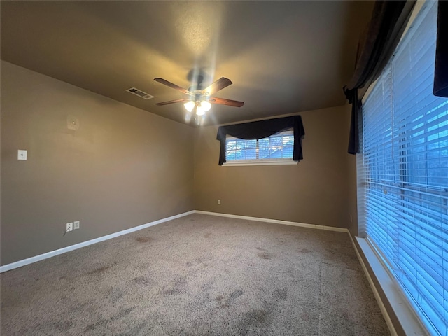 spare room with ceiling fan and carpet floors