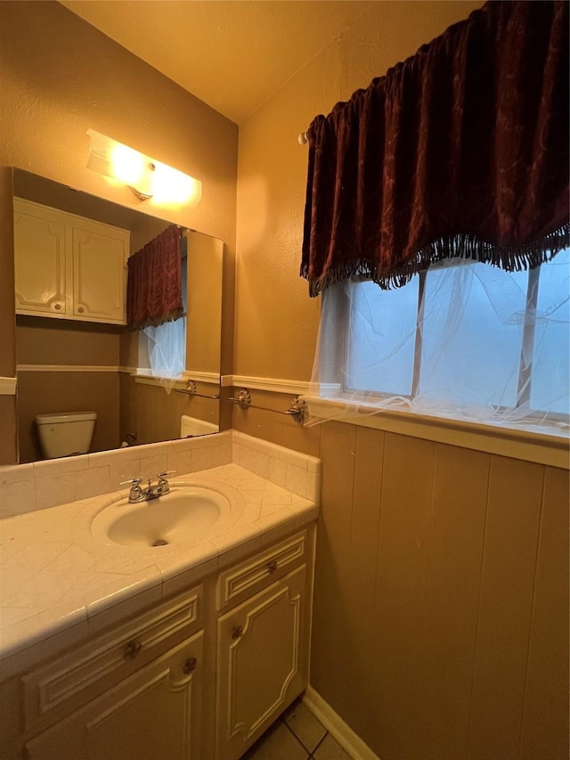 bathroom with tile patterned floors, vanity, and toilet