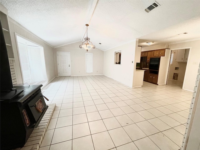 unfurnished living room with a notable chandelier, lofted ceiling, a textured ceiling, and light tile patterned floors