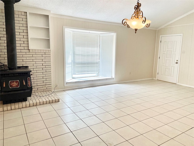 unfurnished living room with a wood stove, built in features, a textured ceiling, light tile patterned floors, and ornamental molding