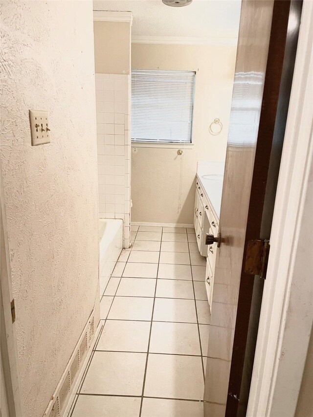 bathroom featuring vanity, tile patterned floors, and crown molding