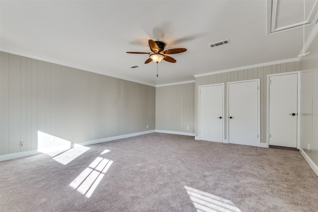 interior space with ceiling fan, light colored carpet, and multiple closets