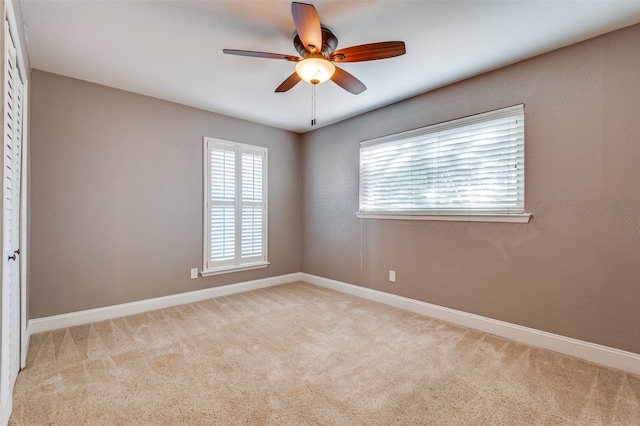 carpeted empty room with ceiling fan