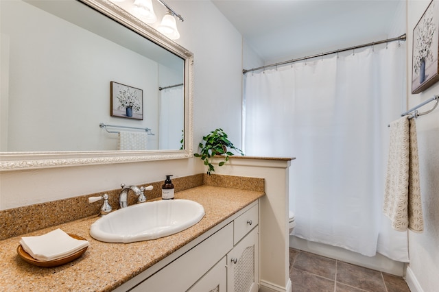 bathroom with tile patterned floors, vanity, and toilet