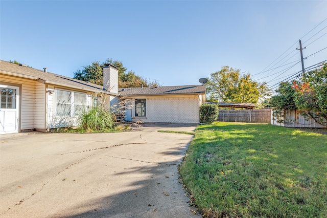 ranch-style home with a front lawn