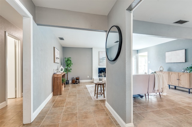 hall with light tile patterned floors