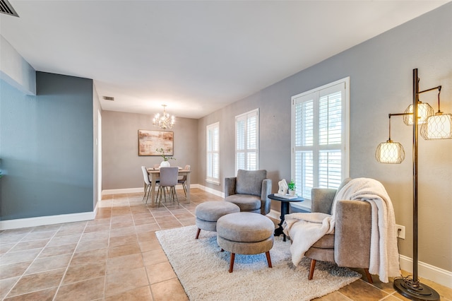 sitting room featuring light tile patterned floors and a chandelier