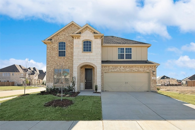 view of front of property with a garage and a front lawn