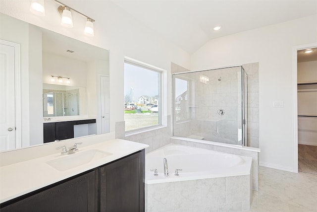 bathroom with vanity, lofted ceiling, and plus walk in shower