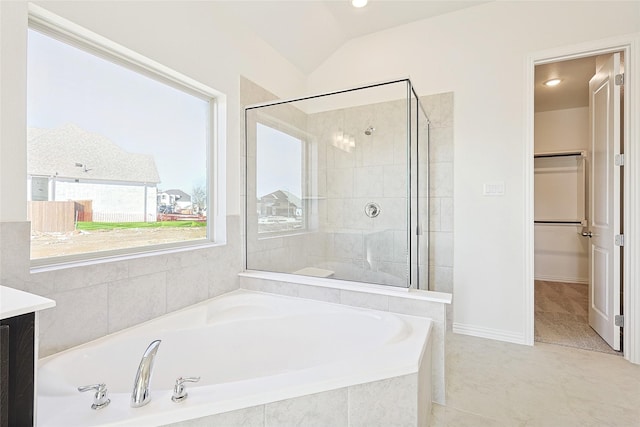 bathroom featuring lofted ceiling, vanity, tile patterned flooring, and separate shower and tub