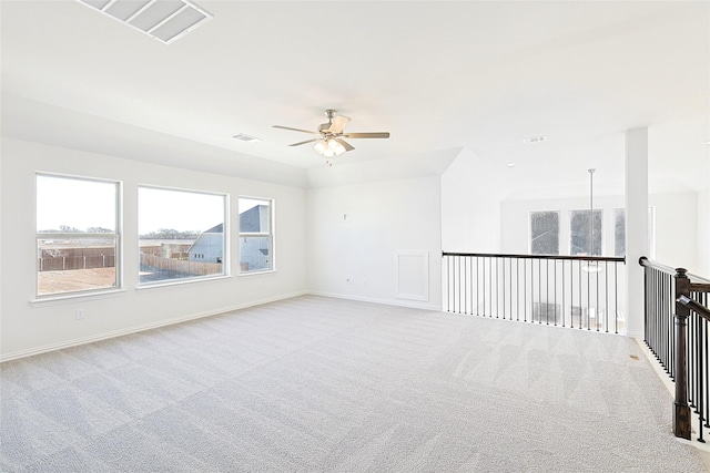 empty room with light colored carpet and ceiling fan